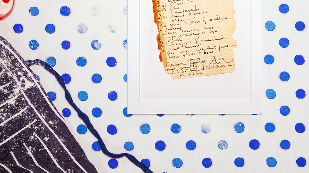 Food recipe framed next to oven gloves and wooden spoon