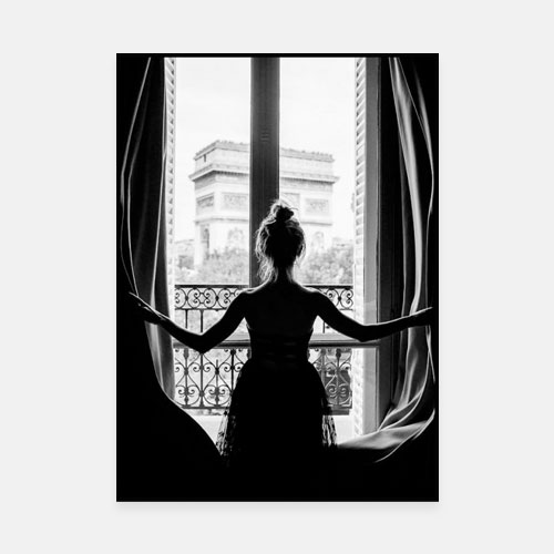 A black and white picture of a young woman looking out onto the Arc de Triomphe